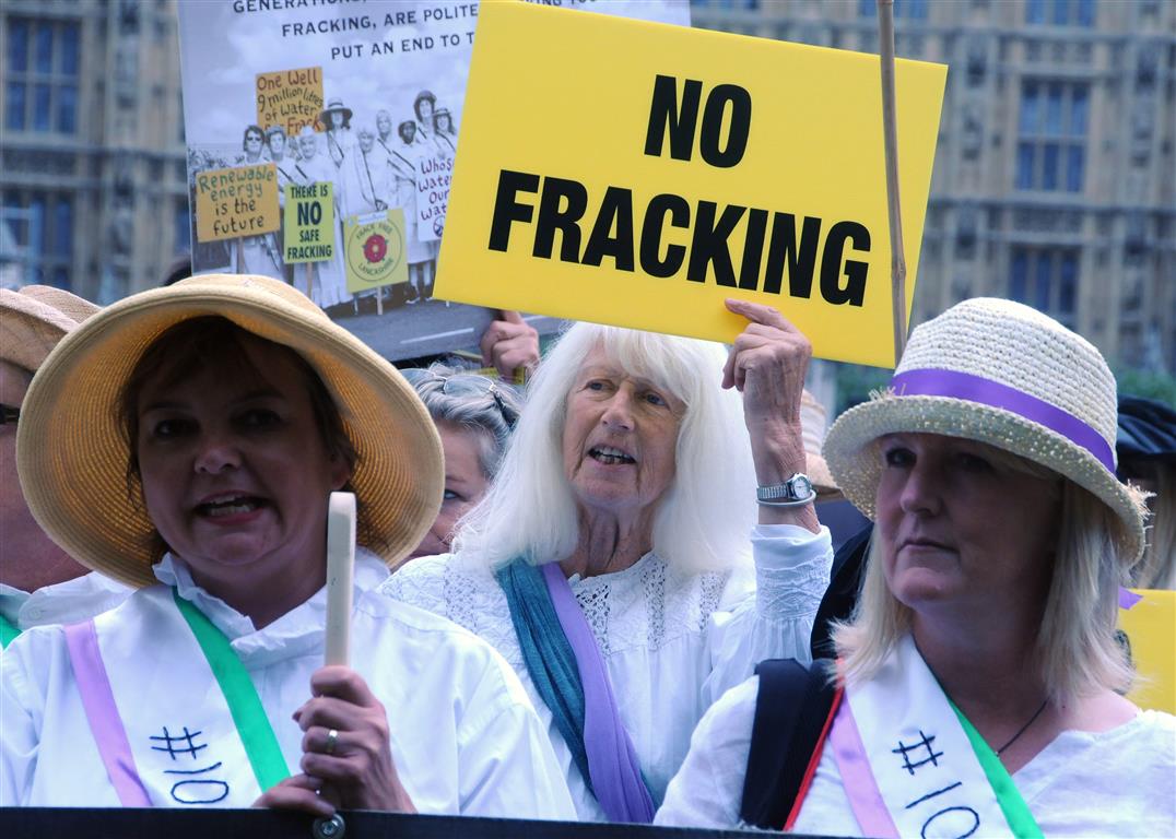 Suffragettes of today against fracking and for democracy outside Parliament